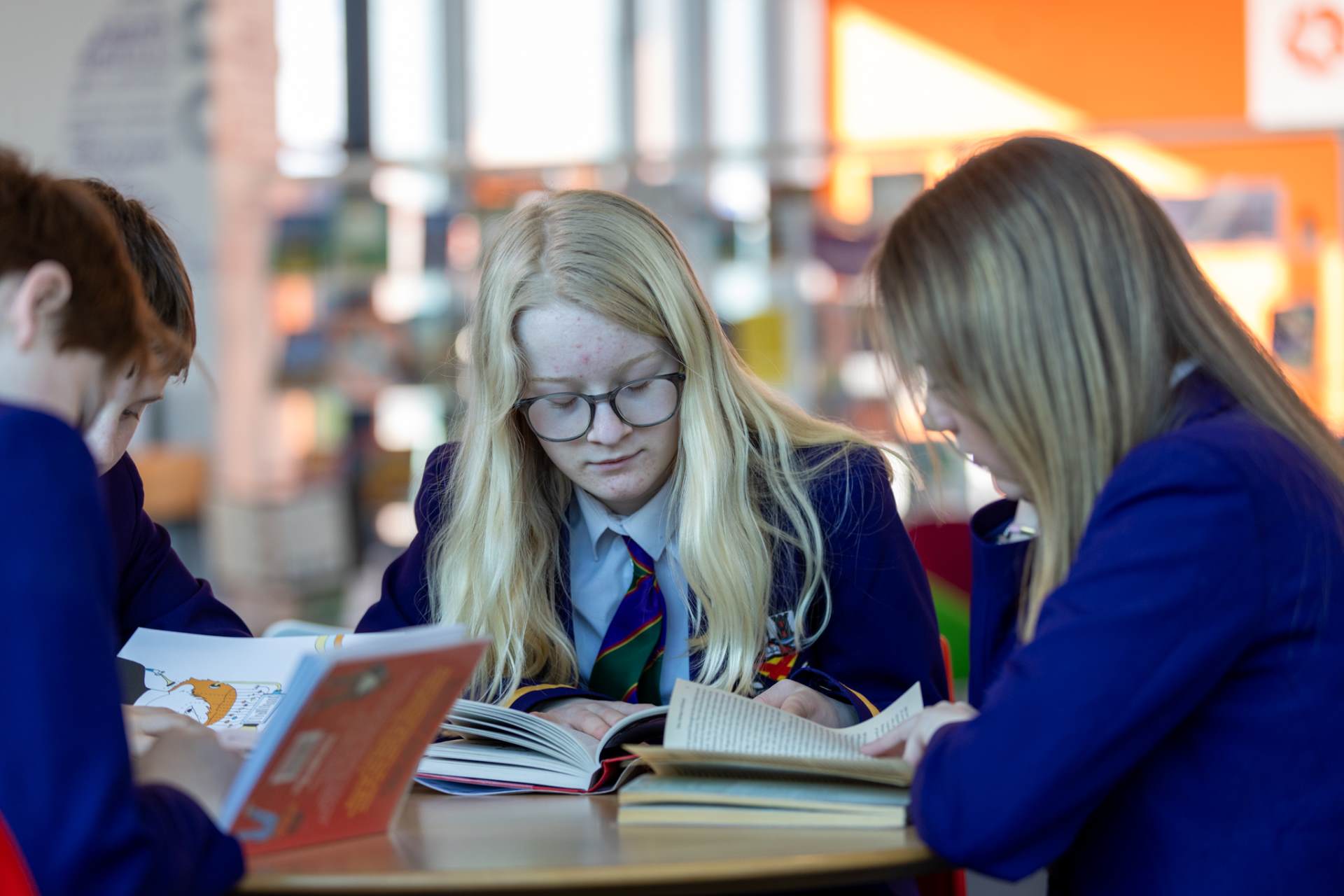 Pupils studying and wearing uniform